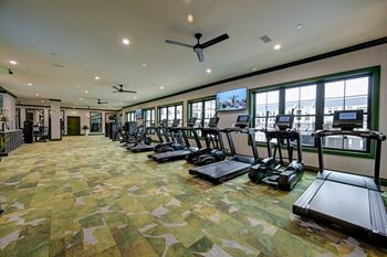 A gym with treadmills and exercise bikes.